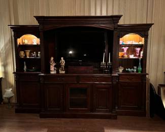 Large Wall Unit. Holds over-sized TV. Conceals equipment. Doors and drawers. Both end cabinets have built in lighting. Mint condition.
