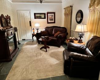 Cigar Room: leather love seat and recliner. Electric fireplace which flames make the room glow and blows heat for the effect.