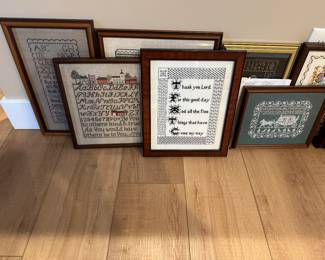 Many hand-crafted framed needlepoint pieces 