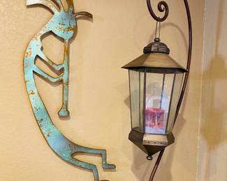 large iron kokopelli sculpture, standing lantern