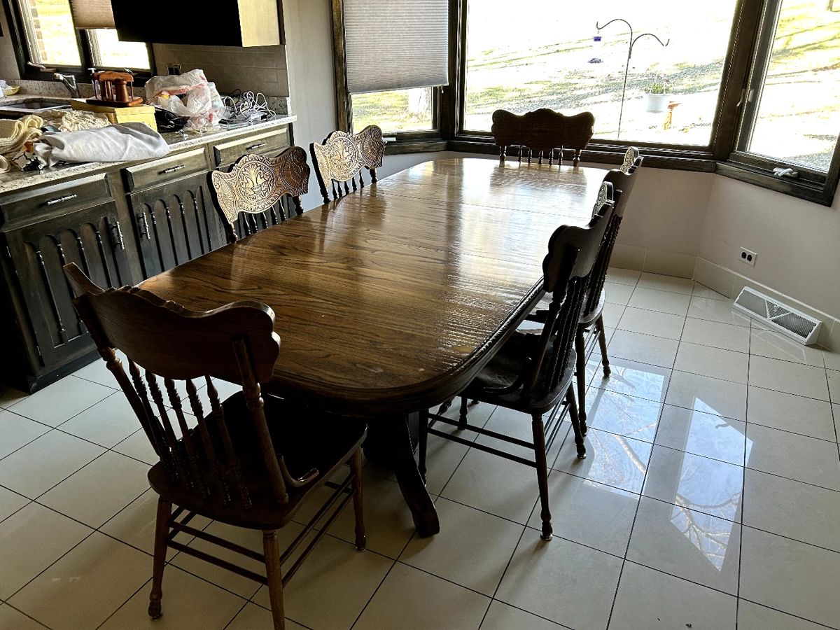 Kitchen table with leaf and 8 chairs. Some chairs need repair.