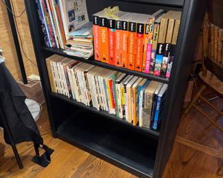 Just one of the many free standing book cases in the house. This one has travel books.