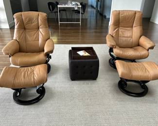 The Admiral Medium Chair and Ottoman, designed by Ekornes of Norway, has a classic design with cutting edge comfort technology. Available with a classic teak base and sand Paloma leather upholstery, this piece provides full-body support, with an ample pillow-like headrest, and matching stiching. Admiral is equipped with Stressless® Plus™ and Glide systems, which allow the chair to provide continuous support for the head and lower back, while also adjusting the reclining angle based on shifts of the body.