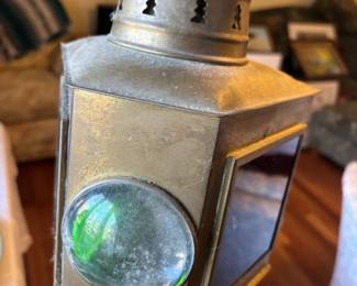 Early 20th century American made brass combination port and starboard small boat bow light. Features a thick green and ruby red thick bull's eye glass lamp lense on either side, and the chimney with christmas tree vents.