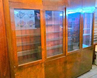 Large 4 section wood & glass display wall unit, with storage on the top & bottom.