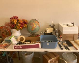 Misc items.
World globe, atlas book on bottom.