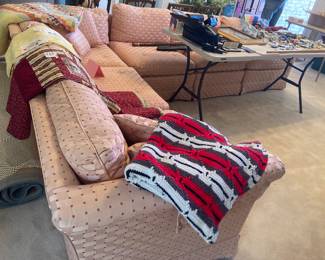 Very Nice pale pink sectional.
Quilts.
