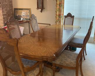 Beautiful vintage table with 2 leaves. Has 6 very nice chairs with cushion seats with cane backs. All in excellent shape. Each end of the table has beautiful scalloped edges.