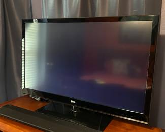 TV and sound bar on stand cabinet