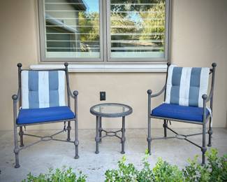 Four black metal outdoor chairs - two have solid blue upper cushions, and two have blue & white striped upper cushions. Three matching metal tables - one circular, one square, and one rectangular.