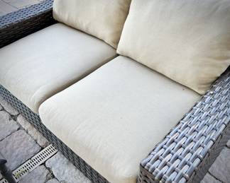 Outdoor woven loveseat.