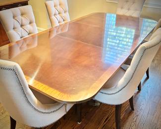 Mahogany dining table with two leaves (one shown).