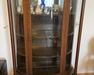 Antique curved glass curio cabinet