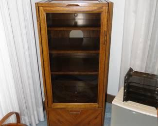 Once upon a time, this smoky glass front case held DVD's and Beta Max tapes. It could also hold some amazing stereo equipment too, as the top does lift up to support the ability to have a record player
