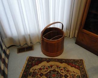 Tis a wooden bucket with dividers, so it can hold anything