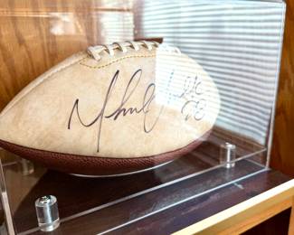 $150; signed Marshall Faulk football in acrylic case