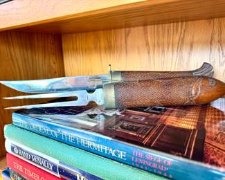 SOLD made in India, hand-carved wooden fish fork and knife carving set; 17"l. Close up of fork and knife out of sleeves.