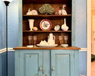 $300; Shabby chic blue painted step back cupboard with shelving and 2 doors; 44x18x82. $200; set of 5 vintage Mexican high ball glasses with sterling floral trellis overlay (top center). $40; Wedgewood cream on cream vase (center left). $38; ceramic seashell vase (center right). $160; Rosenthal Romance coffee pot, creamer, sugar set. $100; Rosenthal Romance oval serving platter. $18; Rosenthal Romance salt and pepper set, as is (bottom center). $24; set of 4 vintage etched wine goblets (bottom left and right).