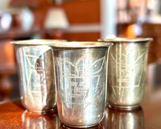 $90; set of three sterling silver Kiddish cups and trays with detailed etchings; 2"h