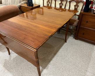 Solid wood table, drop leaf - with 2 leafs.  Nice quality.