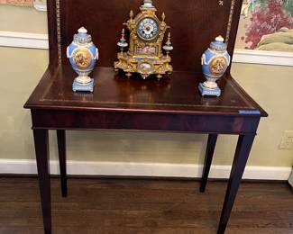 Leather top game table, antique French clock, French porcelain