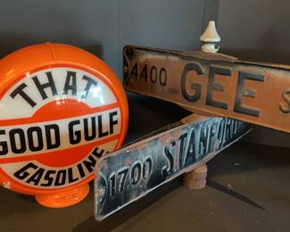 Street sign and plastic gasoline globe sign