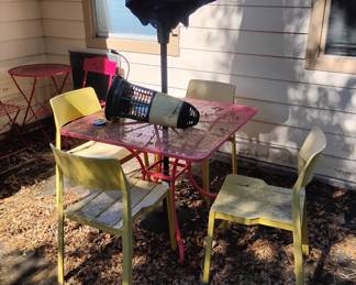 Small cast iron tables and sun umbrella at front entrance