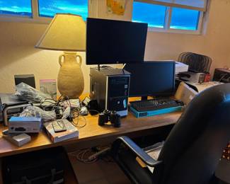 Computers, desk and laptop, many small electronics
