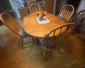 Solid oak kitchen table with extension and 4 chairs.  Approximately 60" x 42" with extension.  May remove 18" extension to make it 42" round.  $200