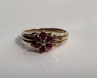 Lot # : 38 - 10k yellow gold ring w/6 rubies & diamond center
