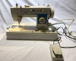 Lot # : 321f - Dressmaker model 2402 sewing machine with accessories and hard case
