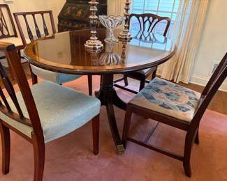 Round, banded mahogany, pedestal breakfast table, with extension leaf.