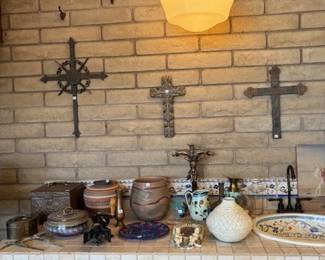 Religious Crosses and Pottery Display
A wall-mounted collection of decorative crosses paired with a countertop display of vintage and handcrafted pottery. A perfect mix of rustic and religious charm.