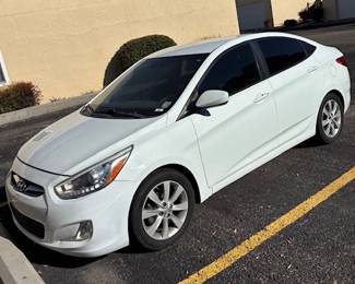2014 Hyundai Accent - Exterior
A sleek white 2014 Hyundai Accent in excellent condition. Its stylish design, tinted windows, and smooth lines make it a practical and reliable compact sedan.