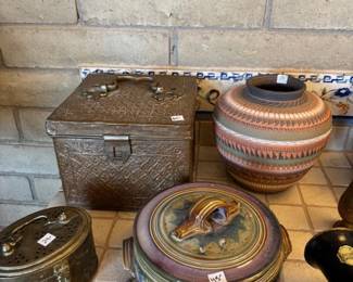 Decorative Pottery and Metal Containers
A collection of beautifully crafted pottery pieces alongside intricate metal storage boxes. Each item features unique designs and patterns, making them ideal for collectors or home decorators.
