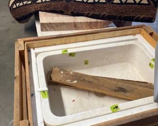 Marble Sink and Rugs
A marble utility sink packed in a wooden crate, accompanied by rolled-up decorative rugs. Ideal for home renovations or interior design projects.