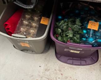 Christmas Decorations in Storage Bins
Two storage bins filled with holiday decorations, including golden ornaments, artificial holly, and vibrant blue and green Christmas baubles. A convenient bundle for holiday preparations.