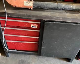 Red and Black Tool Cabinet
A sturdy red and black tool cabinet, complete with multiple drawers and a secure storage compartment. Ideal for organizing tools and equipment in a workshop or garage.