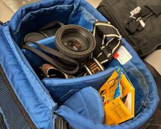 Camera Bag with Accessories
A padded camera bag complete with lenses, film rolls, and other camera accessories. A great package for photography enthusiasts or professionals.