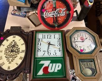 A great selection of vintage advertising clocks and signs