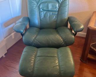 Green leather armchair with matching foot rest