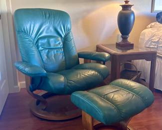 Green leather armchair with matching foot rest