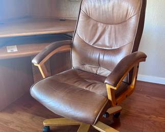 Rolling and swiveling office armchair