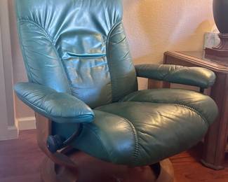 Green leather armchair with matching foot rest