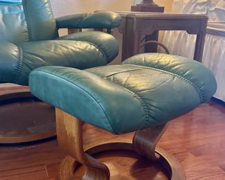 Green leather armchair with matching foot rest