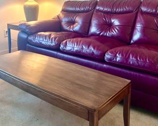 Burgundy leather sofa and wood coffee table