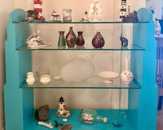 Display items and blues display shelf with glass shelving 
