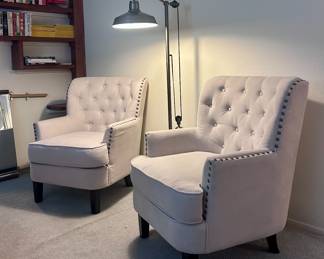 2 white studded arm chairs