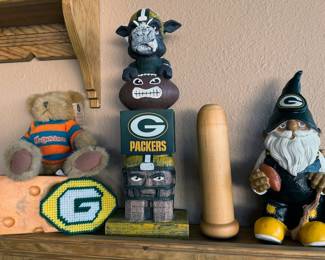 Green Bay Packers NFL memorabilia: beer steins, coffee mugs, tire cover, gnome, cutting board