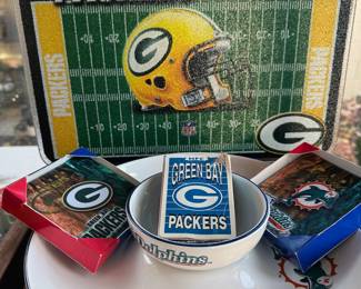 Green Bay Packers NFL memorabilia: beer steins, coffee mugs, tire cover, gnome, cutting board
